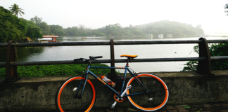 Mumbai City Fights Air Pollution with IIT Bombay’s Cyclothon at Powai Firefox Flip Flop. A fixie docked against the rails adjoining the Powaii lake in the background.